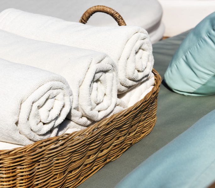 Hotel Towels Rolled in Wooden Basket Hotel Towels Rolled in Wooden Basket